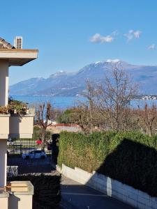 a view of the water and mountains from a house at Vittoria al Lago in Desenzano del Garda