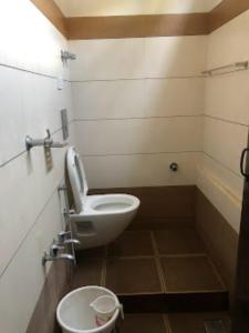 a bathroom with a toilet and a sink at Redbell Suites Manjeri in Manjeri