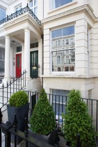 a house with two trees in front of it at Longridge Road Apartments By Viridian Apartments in London