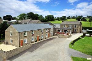 an aerial view of a large house with a driveway at Black Swan Inn in Masham