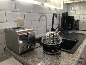 a toaster sitting on a kitchen counter next to a sink at Nikitas rooftop in Kalamata