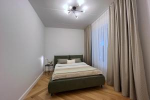 a bedroom with a bed and a ceiling fan at Ambassador Tallinn in Tallinn