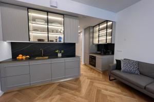 a living room with a couch and a kitchen at Ambassador Tallinn in Tallinn