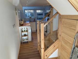 a kitchen with a wooden staircase in a house at Kevalsya in Truro