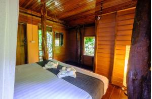 a bedroom with a bed with towels on it at Khao Sok Silver Cliff Resort in Khao Sok