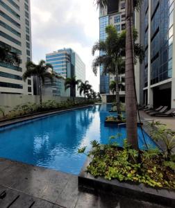 a swimming pool in the middle of a city at PJ PLACE TO STAY at One Eastwood Tower 1 at Unit 26J in Manila