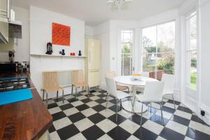 a kitchen with a black and white checkered floor at Stunning large Victorian Maisonette with sea view in Kent