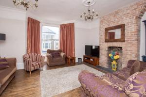 a living room with a couch and a fireplace at Stunning large Victorian Maisonette with sea view in Kent