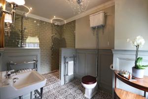 a bathroom with a sink and a toilet at The Georgian Swansea in Swansea