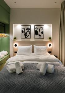 a bedroom with a large bed with two pillows on it at Plane Tree Luxury Suites in Ioannina