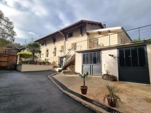 a large house with a garage and a driveway at La voute du pilat in Saint-Chamond