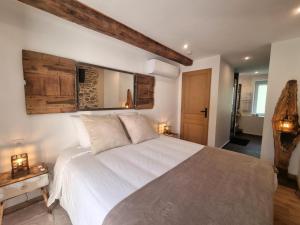 a bedroom with a large white bed in a room at La voute du pilat in Saint-Chamond