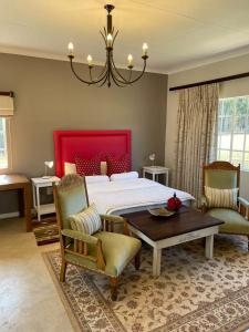 a bedroom with a bed and a table and chairs at Rocks & Roses Farm stay in Lochiel