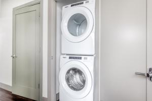 a washer and dryer in a room with a door at New build Sommerville 2BR w Rooftop WD in unit BOS-366 in Somerville