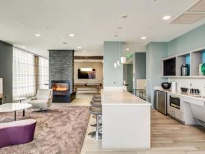 a lobby with a bar and a fireplace at Newly development 1BR w WD Gym in Cambridge BOS-462 in Boston