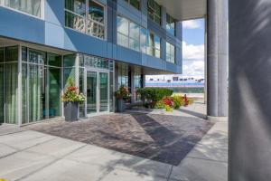 a building with potted plants in front of it at Newly development 1BR w WD Gym in Cambridge BOS-462 in Boston