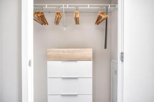 a walk in closet with white cabinets and shoes at N Station Studio w WD Gym nr TD Garden BOS-682 in Boston