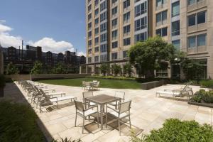a patio with a table and chairs and buildings at E Cambridge 1BR w WD Gym steps from Train BOS-524 in Boston