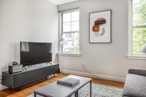 a living room with a tv and a couch at Somerville 1br w wd in building nr Harvard MIT BOS-764 in Cambridge