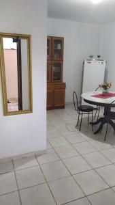 a room with a table and a mirror on the wall at 3 Kitnets in Rio das Ostras +27 photos