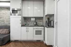 a kitchen with white cabinets and a refrigerator at Luxury Studio Silver in Sofia