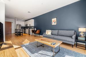 a living room with a couch and a table at S Boston 1BR w Doorman WD nr Seaport BOS-189 in Boston
