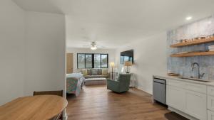 a kitchen and living room with a table and a couch at Hidden Beach 219 in Santa Rosa Beach