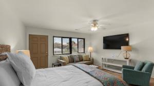 a bedroom with a bed and a flat screen tv at Hidden Beach 219 in Santa Rosa Beach