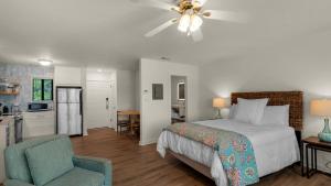 a bedroom with a bed and a chair and a kitchen at Hidden Beach 219 in Santa Rosa Beach +28 photos