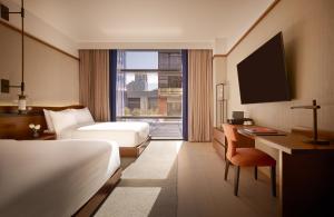 a hotel room with two beds and a desk and a window at Nobu Hotel Atlanta in Atlanta