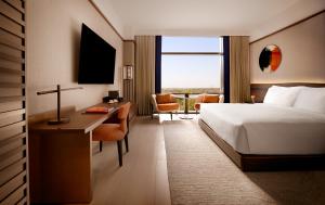 a hotel room with a bed and a desk with a desk at Nobu Hotel Atlanta in Atlanta