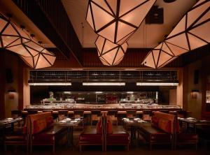 a dining room with tables and chairs and lights at Nobu Hotel Atlanta in Atlanta