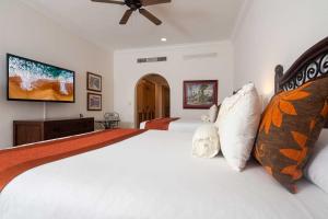 1 dormitorio con 2 camas y TV de pantalla plana en Stunning Cabo San Lucas Villa at 5-Star Resort!, en Cabo San Lucas