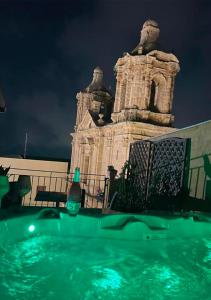 a swimming pool in front of a building at night at Rabatè in Agrigento