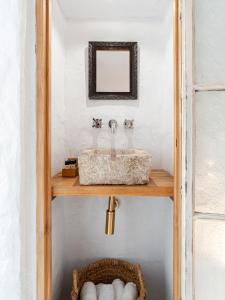 a bathroom with a sink and a mirror at La Fonda Antigua ADULTS ONLY in Vejer de la Frontera