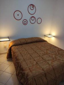 a bedroom with a bed and two lights on the wall at antohouse intero appartamento R5883 in Quartucciu