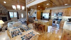 a kitchen and living room in a log cabin at Lakefront Hideaway in Litchfield