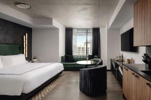 a hotel room with a bed and a kitchen at Thompson Austin, by Hyatt in Austin