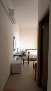 a bedroom with a bed and a table and a chair at Residenza Pitigliano in Pitigliano