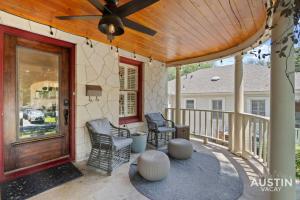 a porch with two chairs and a wooden ceiling at Vibrant, Quirky Home with Hot Tub Near S Congress in Austin