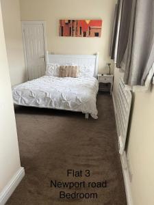 a bedroom with a bed with a white comforter at Stafford apartments in Stafford