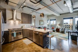 an open kitchen with stainless steel appliances and a living room at Sable 85 - Two Bedroom in Minneapolis
