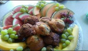 a plate of food with grapes apples and meatballs at Haven on the Hill in Ashville