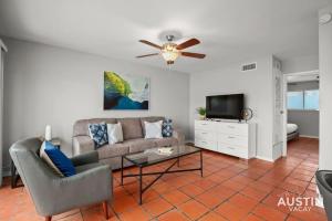 a living room with a couch and a tv at Enjoy Central Austin King Bed Smart TV and AC in Austin