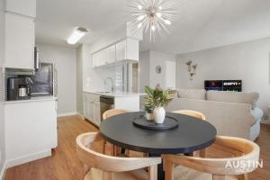 a kitchen and living room with a table and chairs at Cook and Gather Around in a Fully Equipped Apartment in Austin