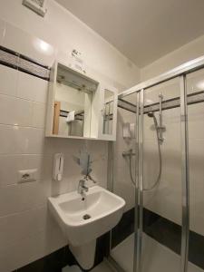 a bathroom with a sink and a shower at Albergo del mera-ristorante da Lui in Sorico