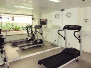 a gym with three treadmills and a mirror at Condomínio Max Savassi Superior apto 1502 in Belo Horizonte