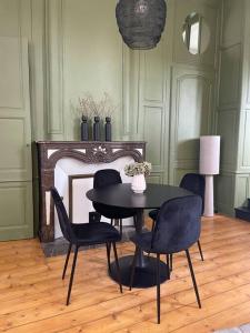 - une salle à manger avec une table et quatre chaises dans l'établissement Appartement 2pers «Le Parisien », à Saint-Omer