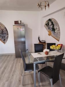 a dining room with a glass table and chairs at Casa Violeta in Aguadulce
