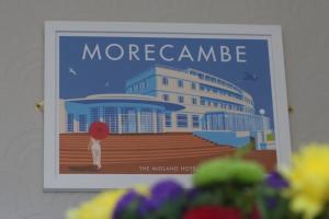 a poster of a building with a person with a red umbrella at Welcoming 2 Bedroom Home with Driveway Parking in Morecambe